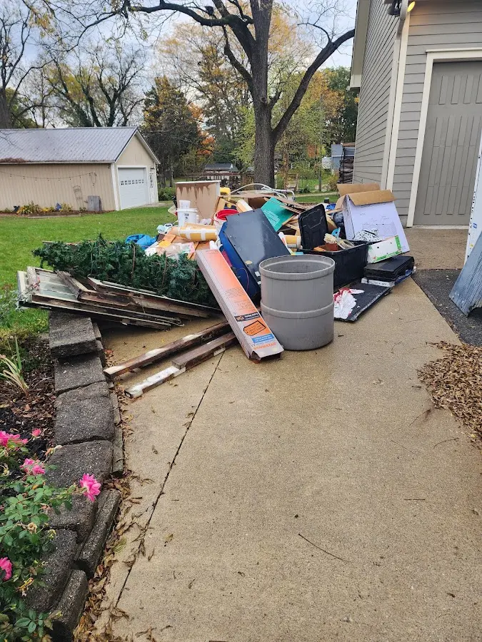 Dumpster being loaded with debris for Estate Cleanout Dumpster Rental in Wapato